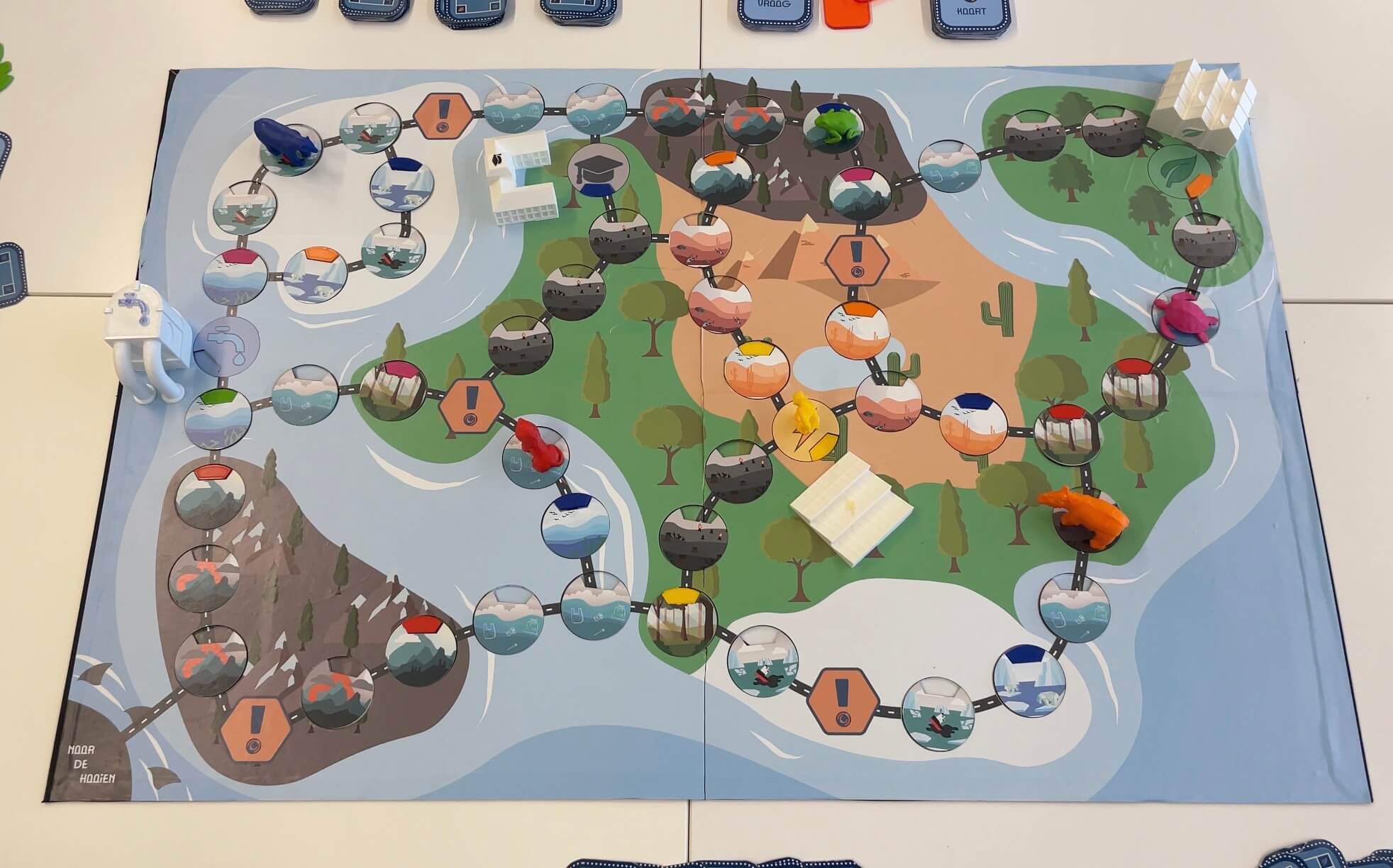 A boardgame with a board that looks like a landscape with various tiles.
